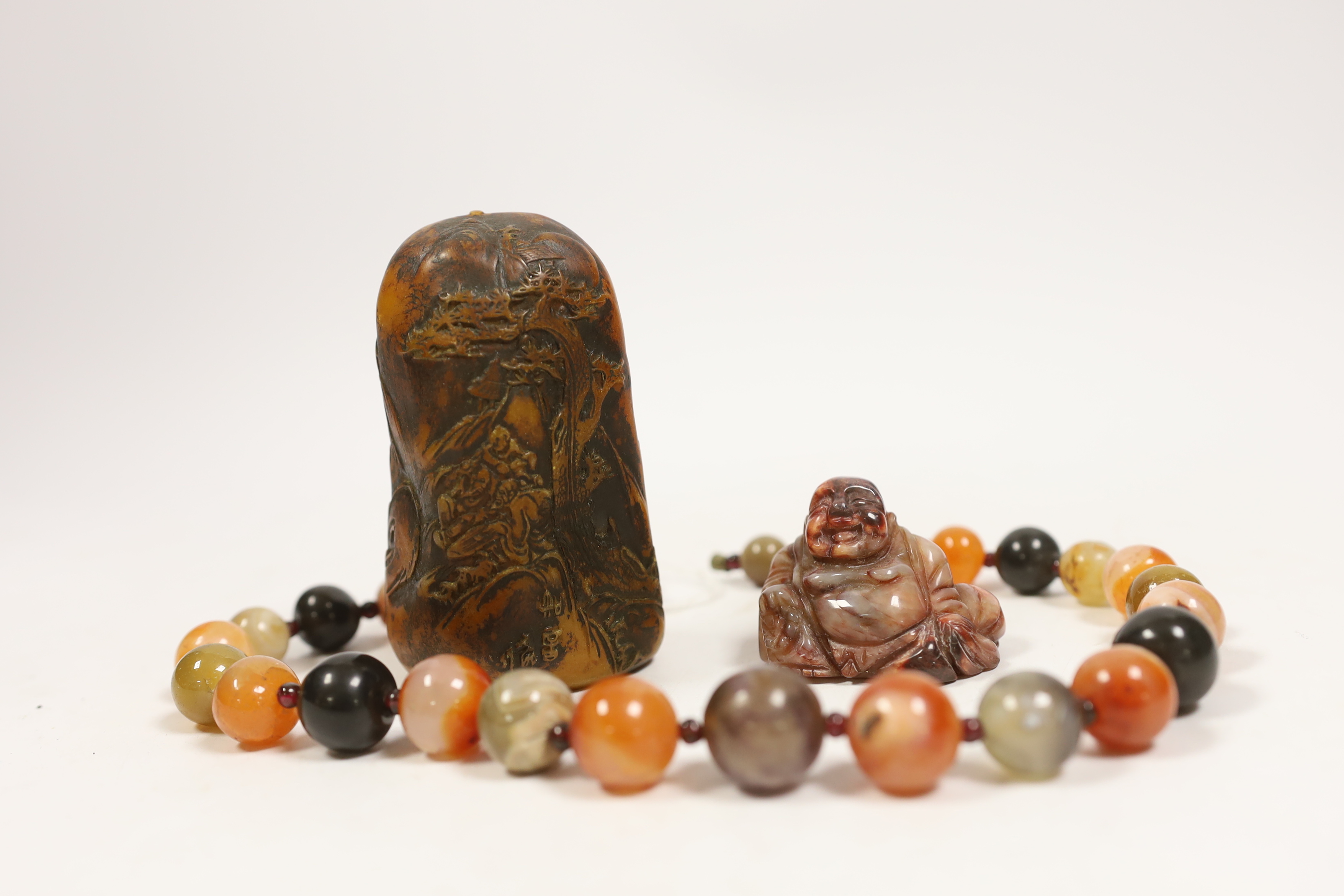 An agate bead necklace, a Chinese soapstone seal and a miniature carved agate Buddha, 4cm